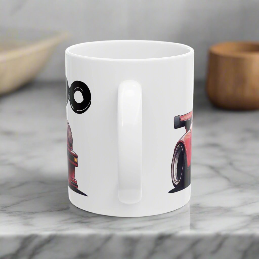 11oz Mug handle view of White Coffee Mug with a red Porsche 930 with the text 'turbo' placed behind the car. 