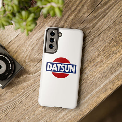 White Samsung Galaxy S21 Datsun phone case on a table with accessories.