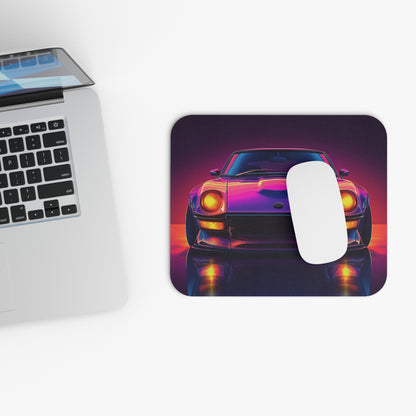 Neon Datsun 240z mouse pad and mouse placed beside a laptop