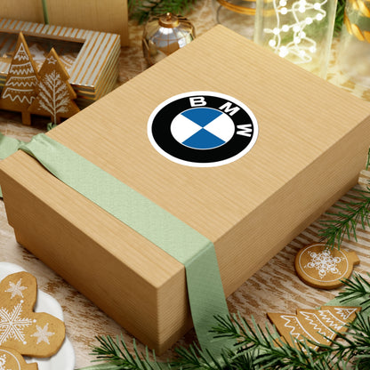 3 inch BMW sticker placed on a cardboard box.. 