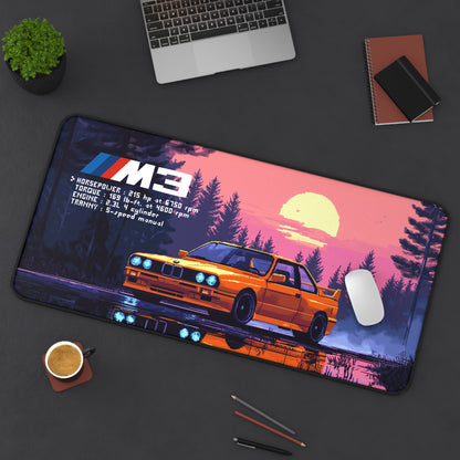 Top view of the 15.5 by 31 deskmat showing the BMW M3 E30 graphic with a mouse and laptop beside it..