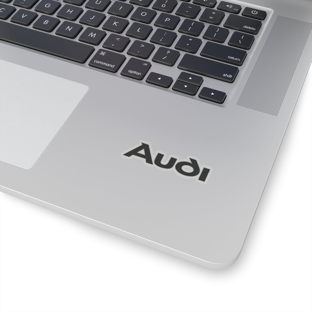 2 inch transparent sticker of the Audi logo on laptop for scale
