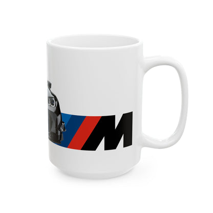 Right side view of the 15oz White Coffee Mug with a BMW M4 GTS with the M emblem placed beside the car. 