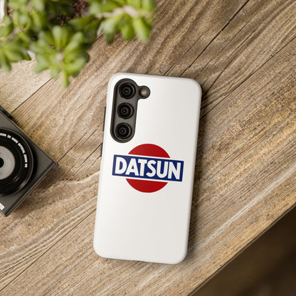 White Samsung Galaxy S23 Datsun phone case on a table with accessories.