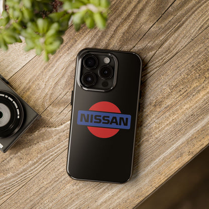 Black iPhone 15 Pro Vintage Nissan phone case on a table with accessories.