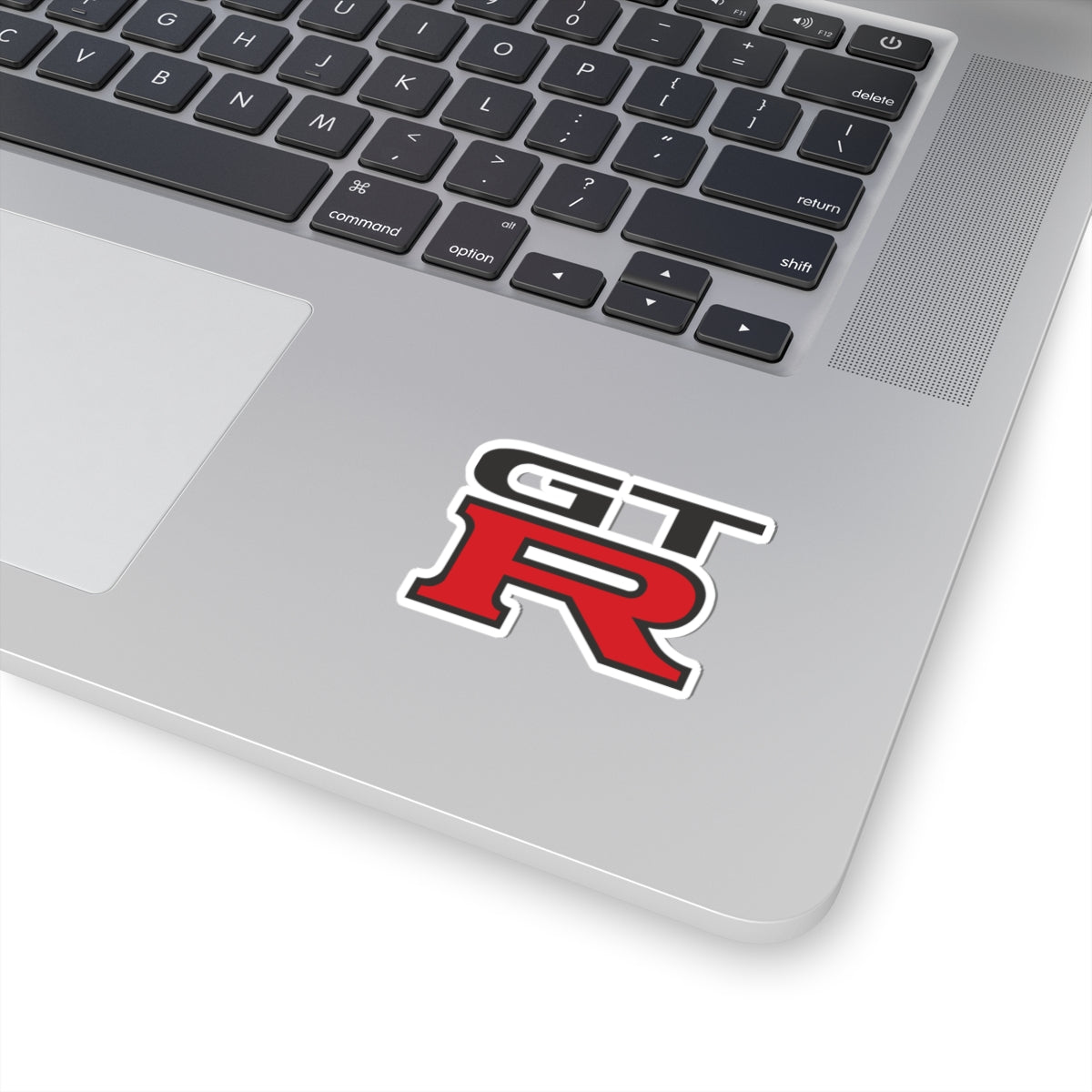 2 inch white GTR sticker on a silver laptop