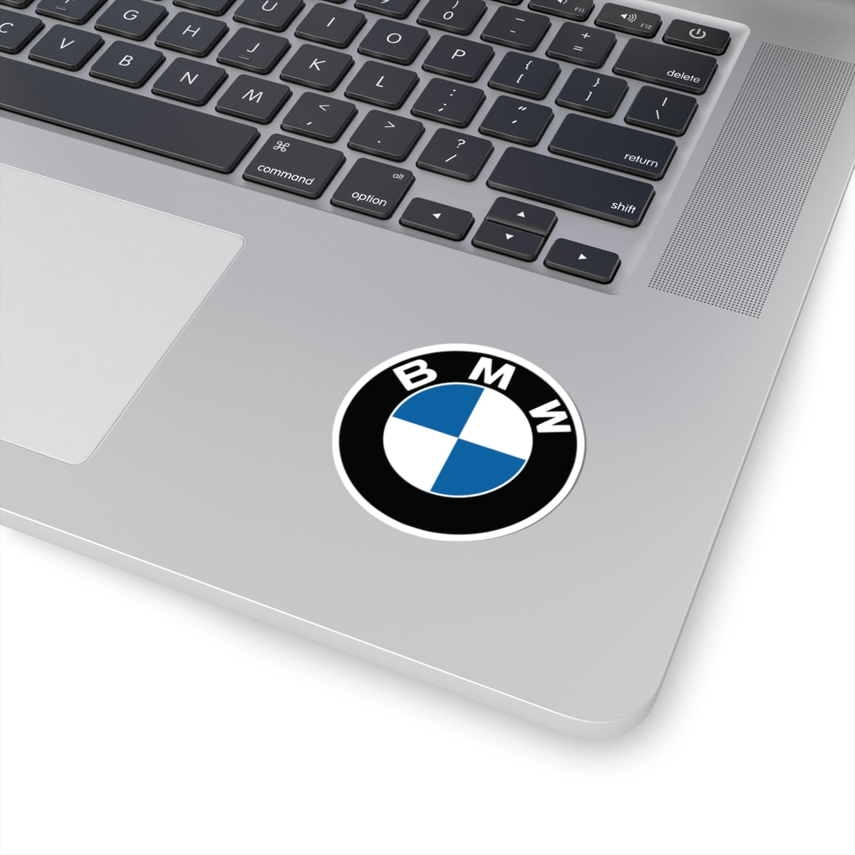 2 inch BMW sticker applied to a silver laptop, highlighting its size and clarity.