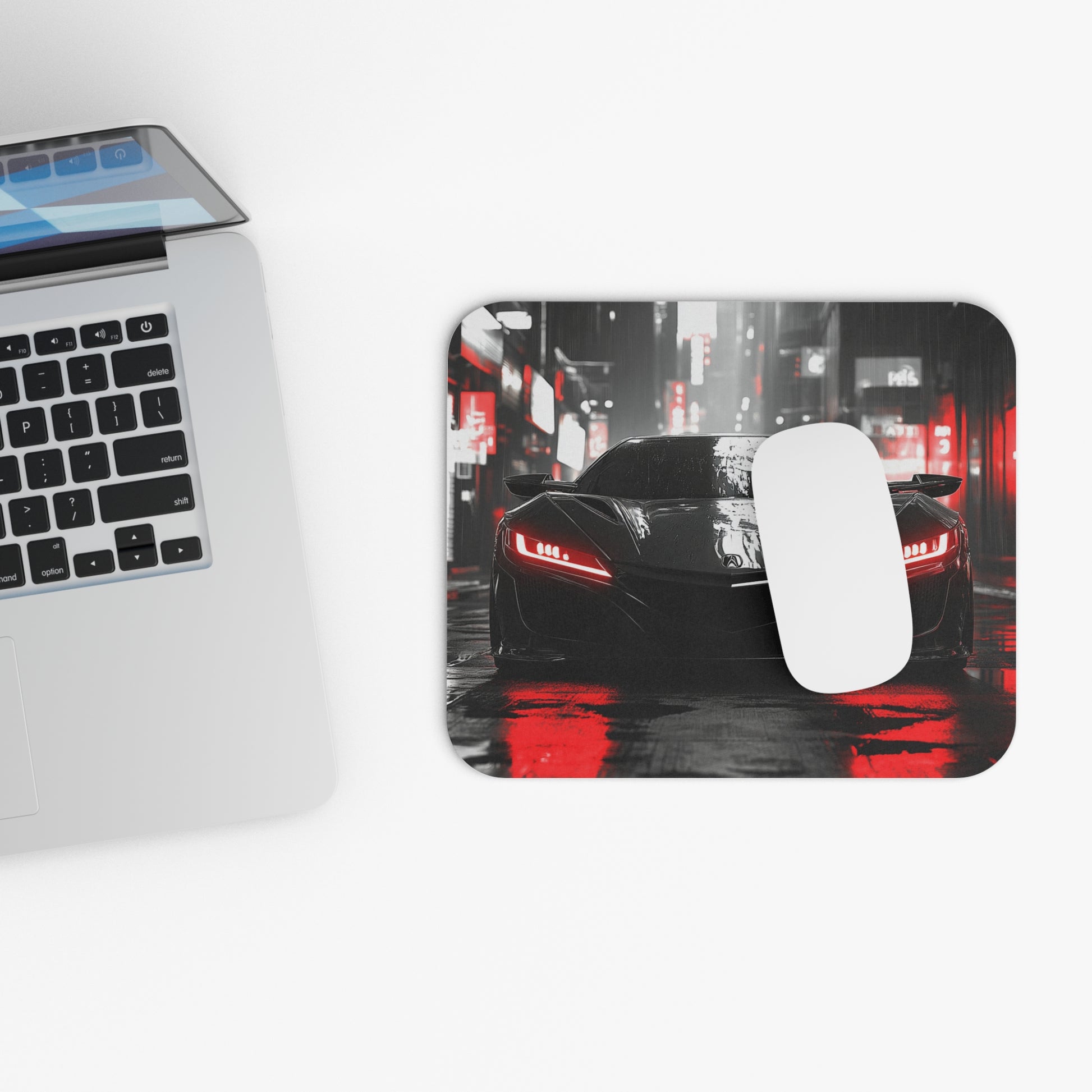 2nd Generation Acura NSX mouse pad and mouse placed beside a laptop