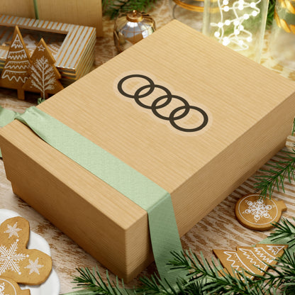 3 inch transparent sticker of the Audi emblem on box for scale
