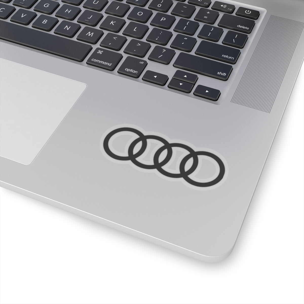 3 inch transparent sticker of the Audi emblem on laptop for scale