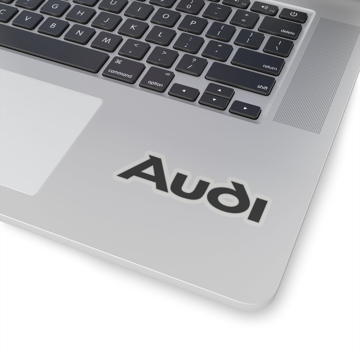 3 inch transparent sticker of the Audi logo on laptop for scale
