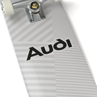 6 inch transparent sticker of the Audi logo on skateboard for scale
