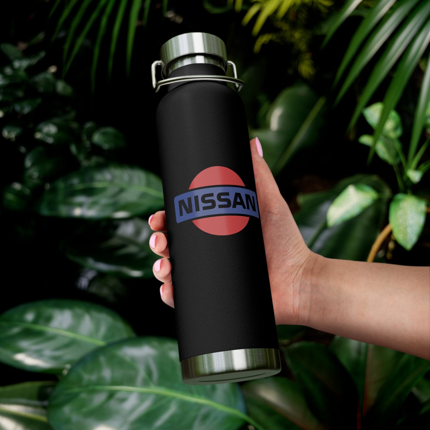 Woman holding the Black Vintage Nissan Water Bottle. The perfect gift for JDM enthusiasts