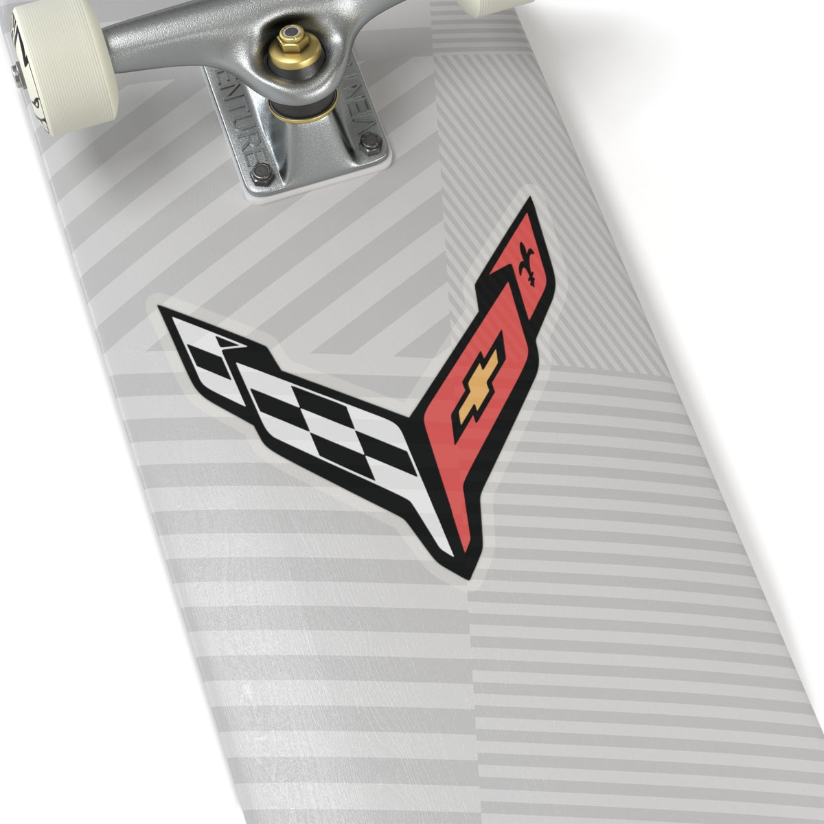 6 inch transparent sticker of the Corvette C8 emblem on skateboard for scale
