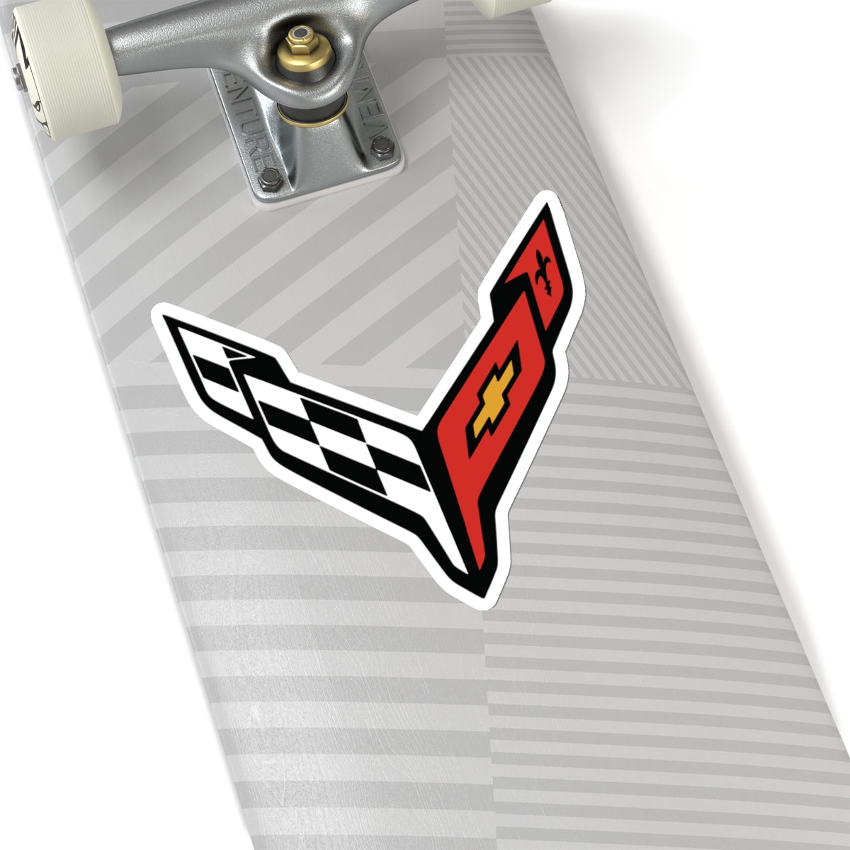 6 inch white sticker of the Corvette C8 emblem on skateboard for scale
