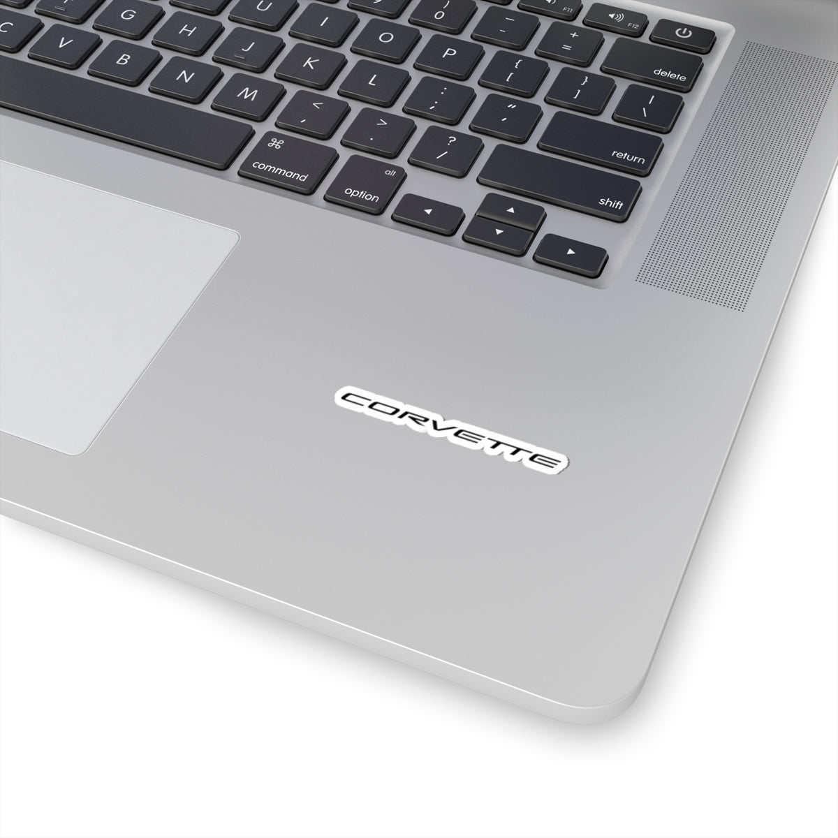 2 inch white Corvette sticker applied to a silver laptop, showcasing its size and placement.