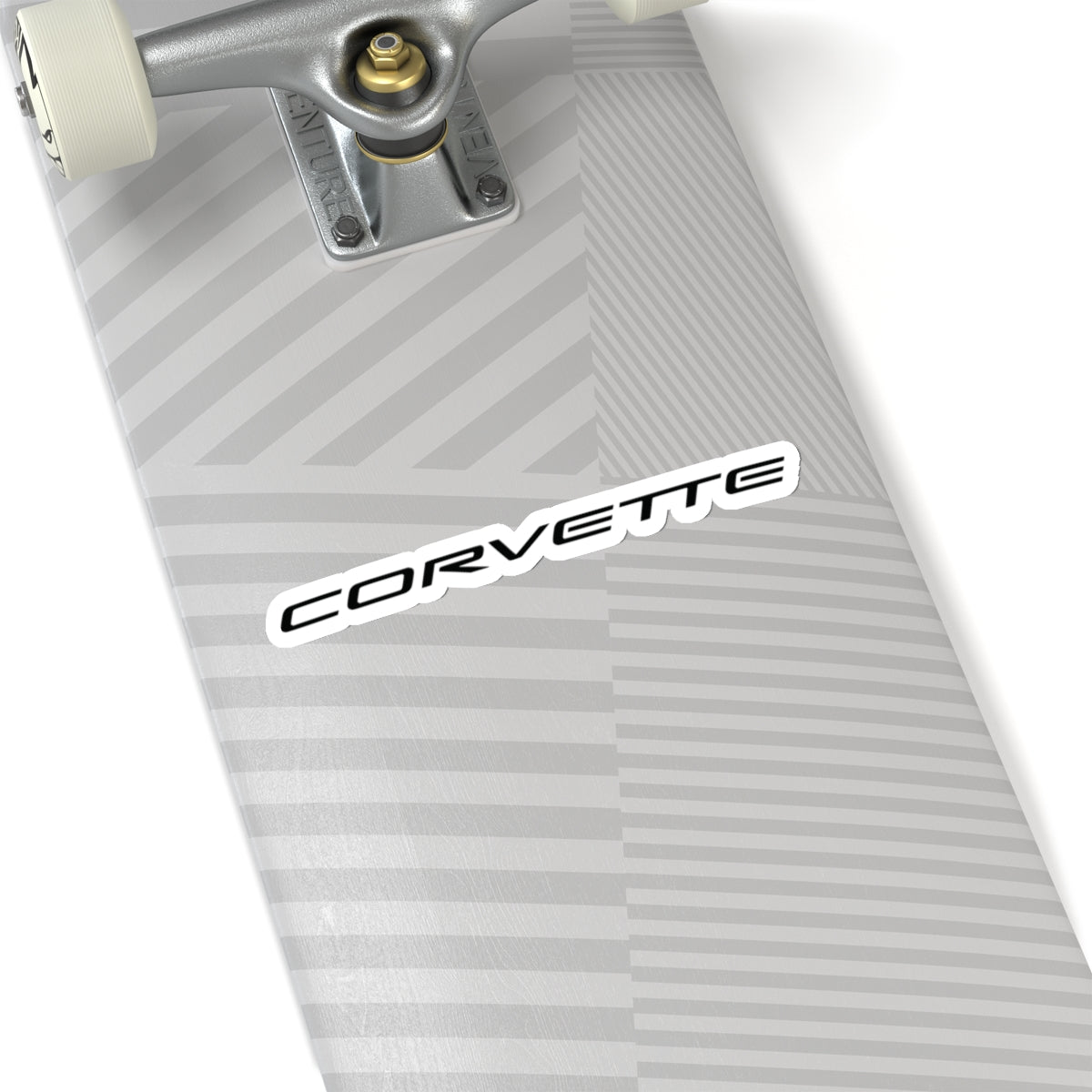 6 inch white Corvette sticker applied to a silver skateboard, showcasing its size and placement.