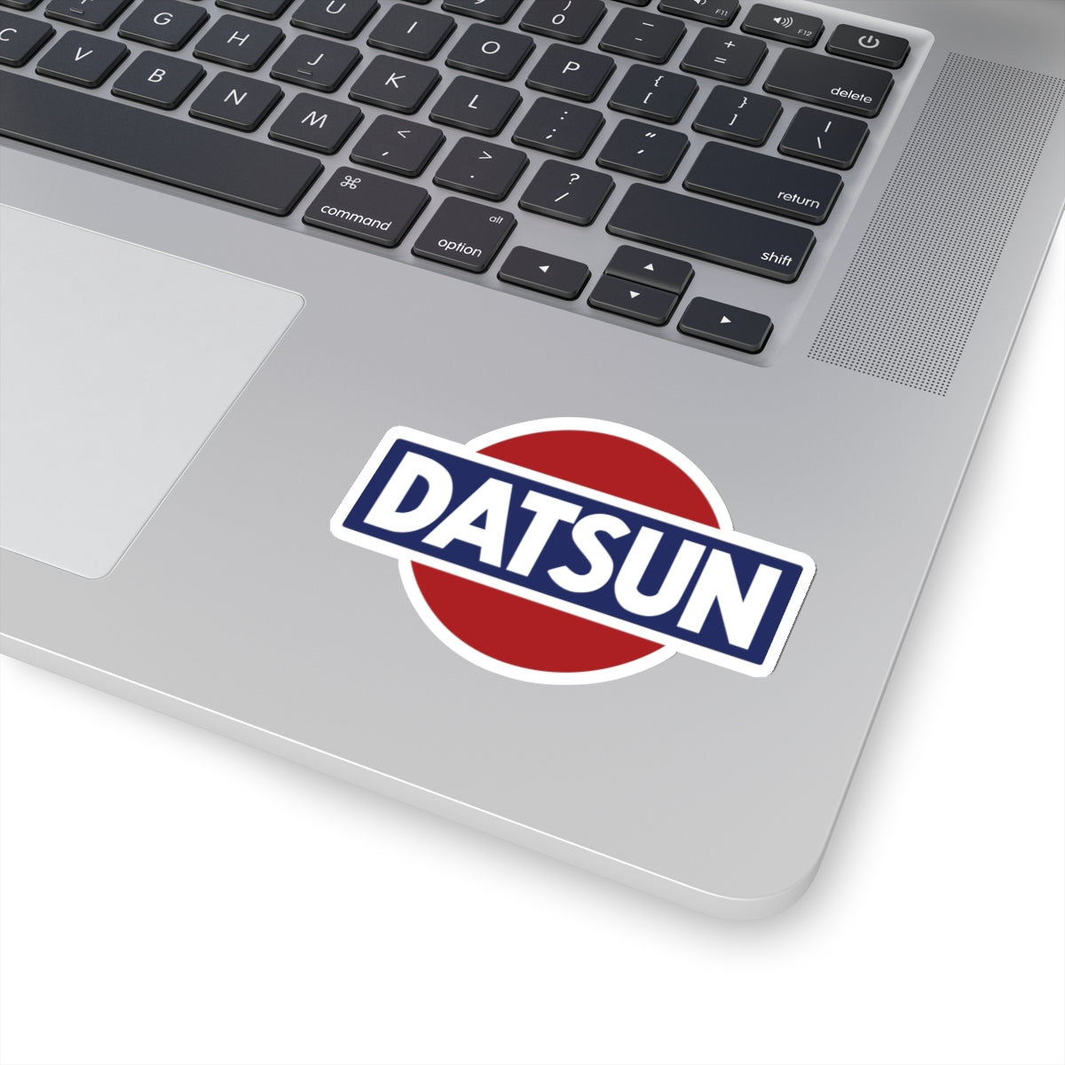 3 inch whtie Vintage Datsun sticker on a silver laptop