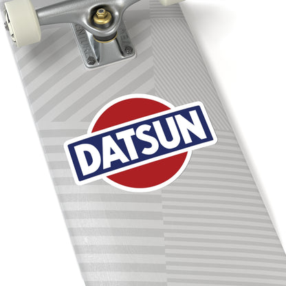 2 inch whtie Vintage Datsun sticker on a silver skateboard deck