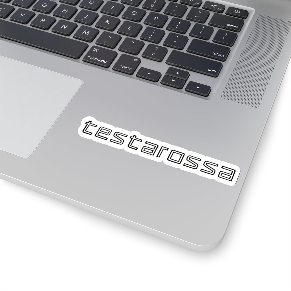 4 inch white Testarossa sticker on a silver laptop