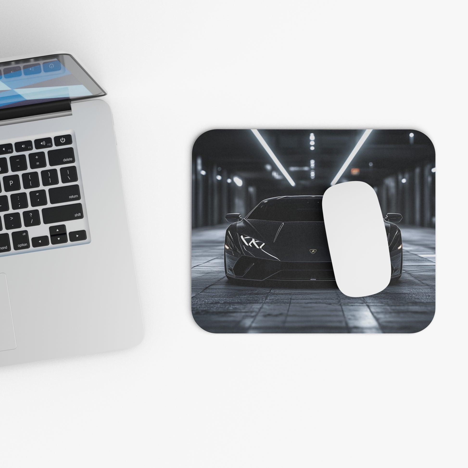 Lamborghini Huracan mouse pad and mouse placed beside a laptop