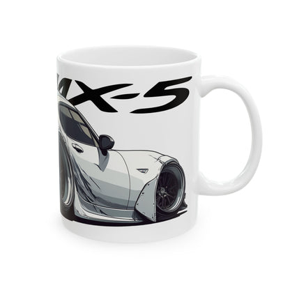 Right view of the 11oz White Coffee Mug with a Mazda MX-5 with the MX-5 emblem placed behind the car. 