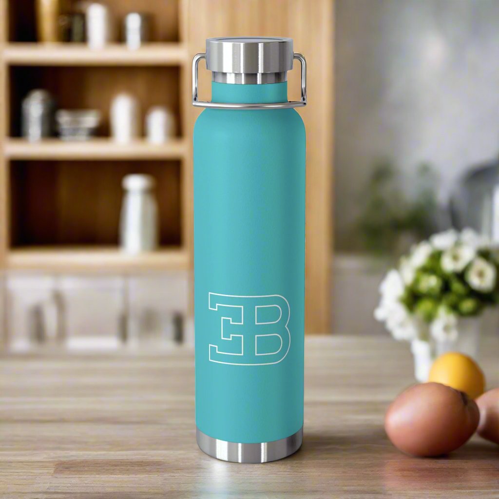 Front View of Mint Green Bugatti Logo Water Bottle in a kitchen. Copper Vacuum Insulated. Premium Bugatti gifts for car enthusiasts