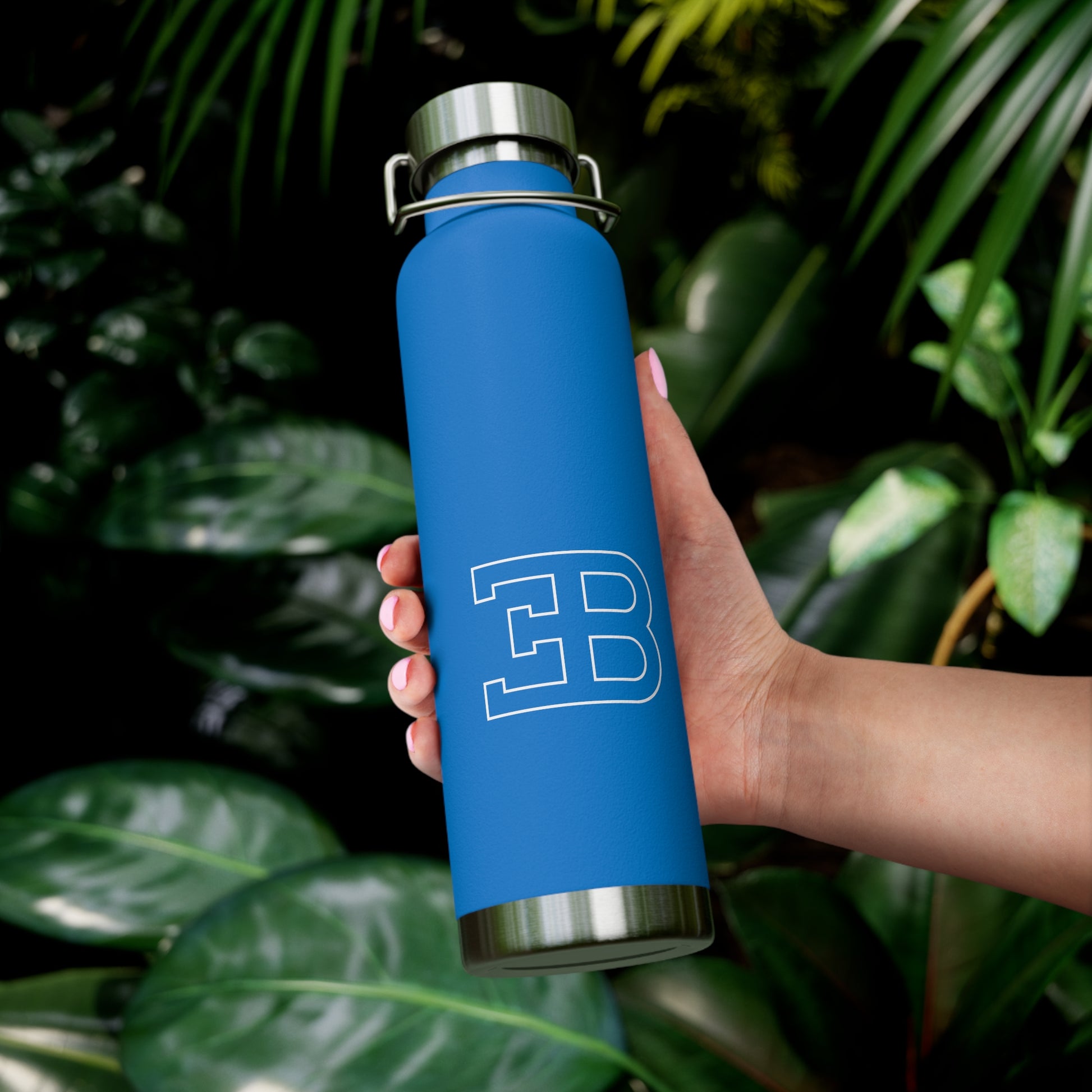 Model holding the Pebble Blue Bugatti Emblem Water Bottle. High-quality Bugatti branded merchandise