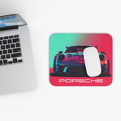 Cyberpunk neon Porsche GT3 mouse pad and mouse placed beside a laptop