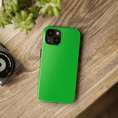 iPhone 15 Porsche Signal Green phone case on a table with accessories. 