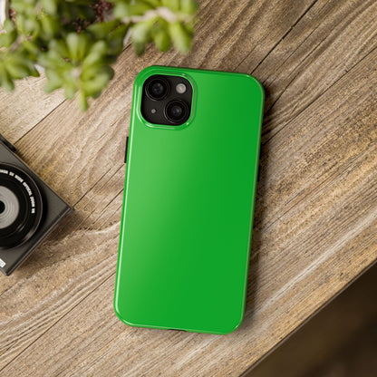 iPhone 15 Plus Porsche Signal Green phone case on a table with accessories. 