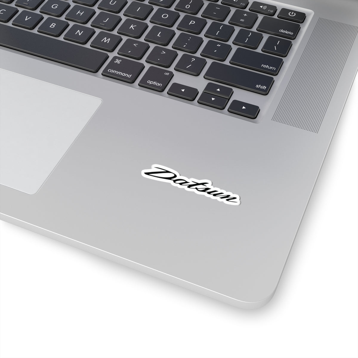 2 inch white Datsun sticker on a silver laptop