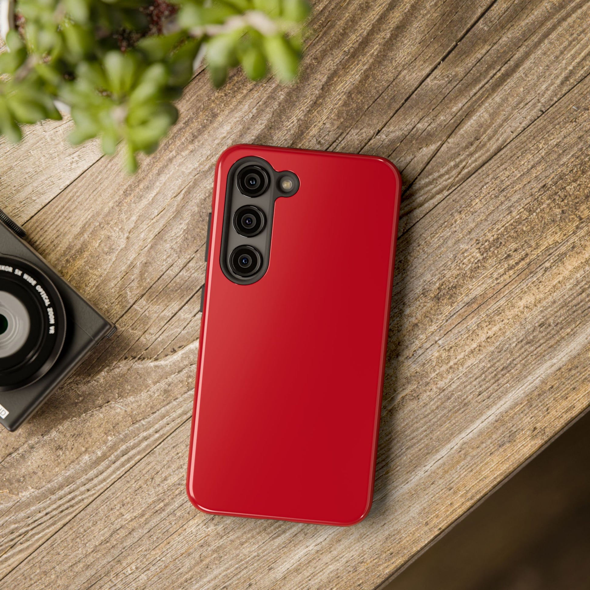 Samsung Galaxy S23 Max Porsche Guards Red phone case on a table with accessories. 