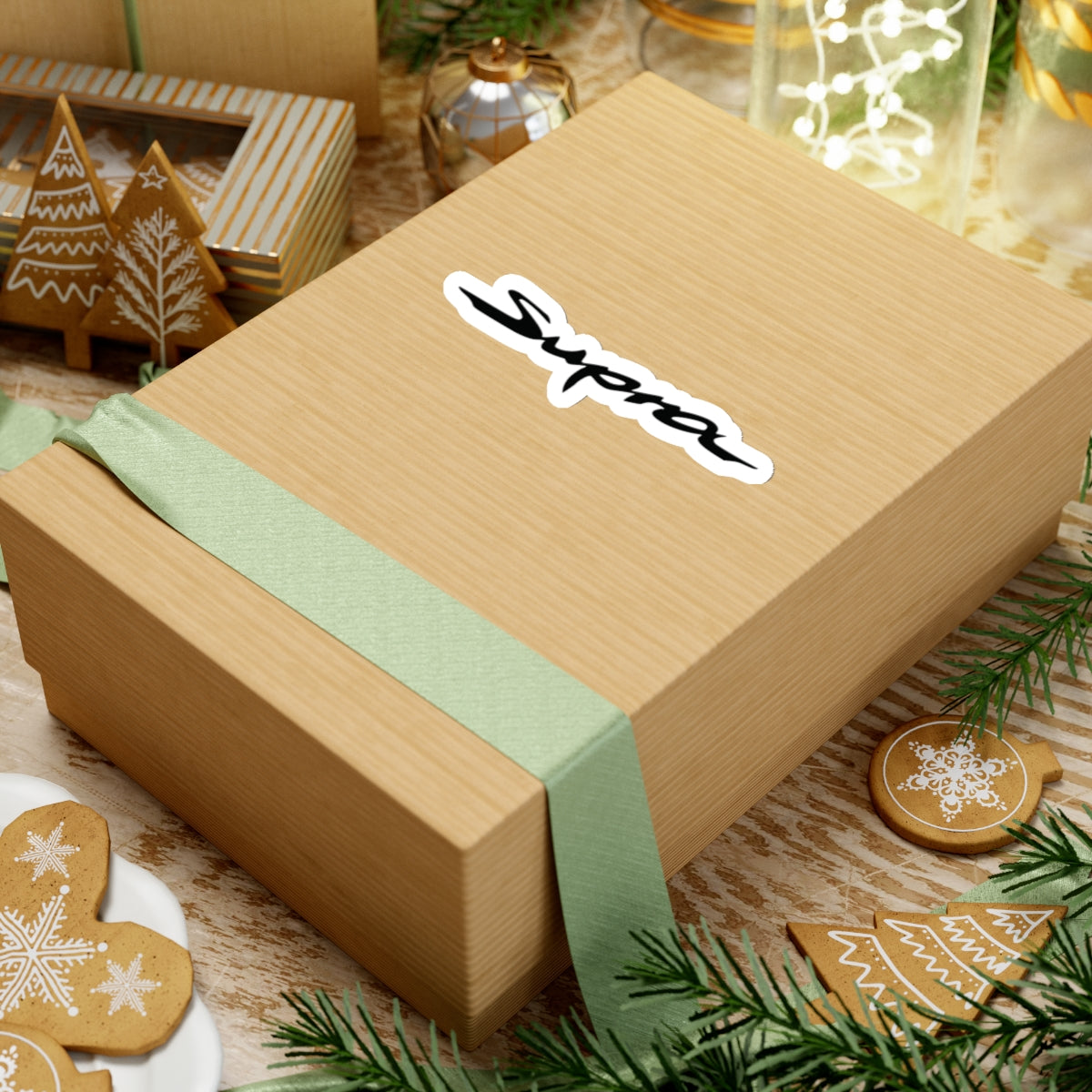 Supra Sticker on a gift box with green ribbon