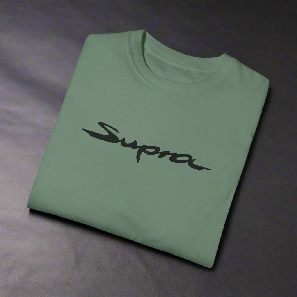 Green Toyota Supra T-Shirt with black text, folded. Shirts for Japanese car fanatics
