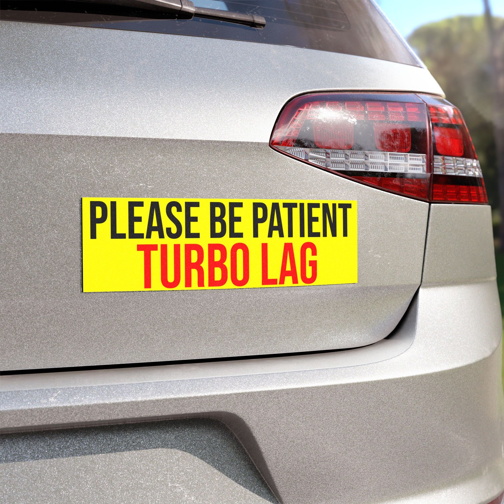 Angled view of the Please Be Patient, Turbo Lag Magnet on the rear end of a car