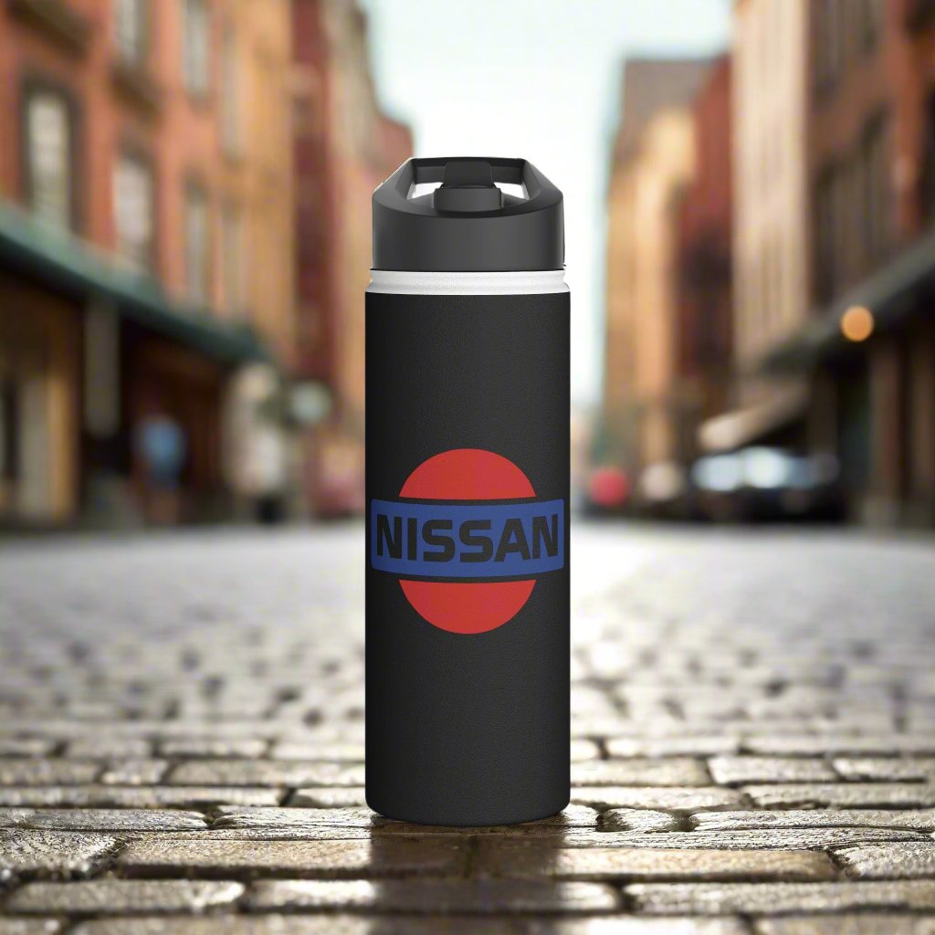 Front View of Black Vintage Nissan Logo Water Bottle on a brick pathway. Water Bottle with Classic Nissan Design