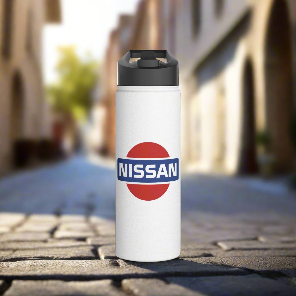 Front View of White Vintage Nissan Logo Water Bottle on a brick pathway. Automotive-Themed Water Bottle.