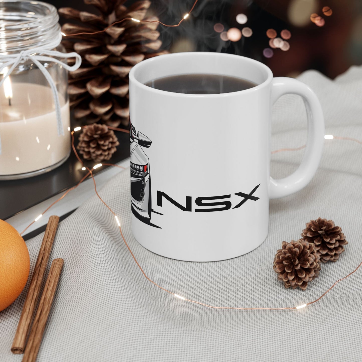 Lifestyle view of the 11oz White Coffee Mug with an Acura NSX with the NSX emblem placed beside the car.   