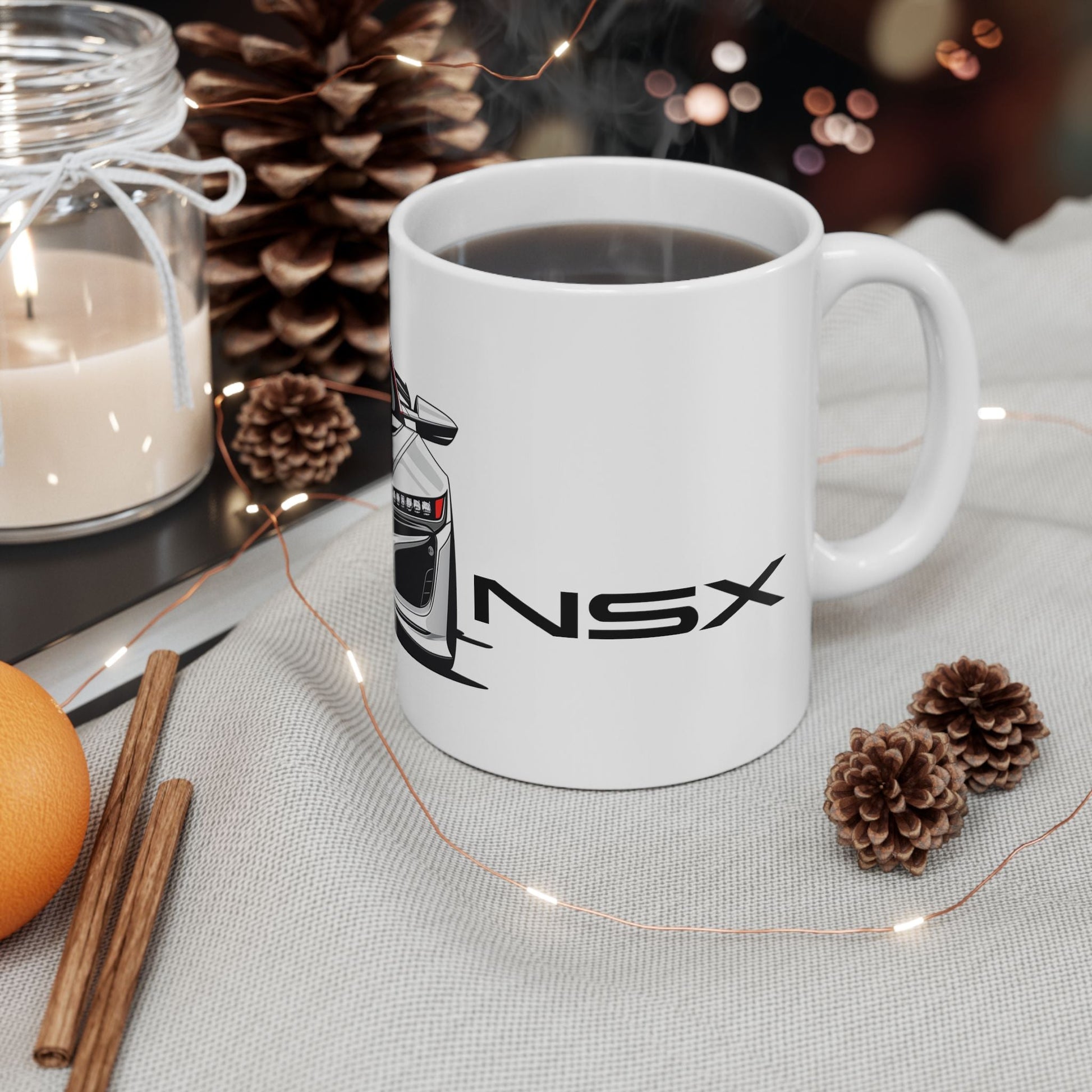 Lifestyle view of the 11oz White Coffee Mug with an Acura NSX with the NSX emblem placed beside the car.   