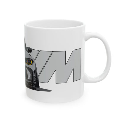 Right view of the 11oz White Coffee Mug with a Grey BMW M4 GTS with the M emblem placed behind the car.  