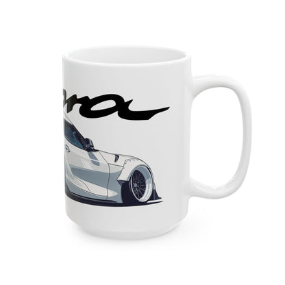 Right side view of the 15oz White Coffee Mug with a 5th Generation Toyota Supra with the Supra emblem placed behind the car. 