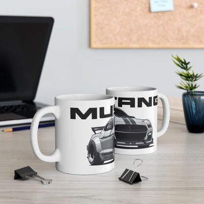 Lifestyle view of the 11oz White Coffee Mug with a Mustang Shelby GT-500 with the Mustang emblem placed behind the car. 