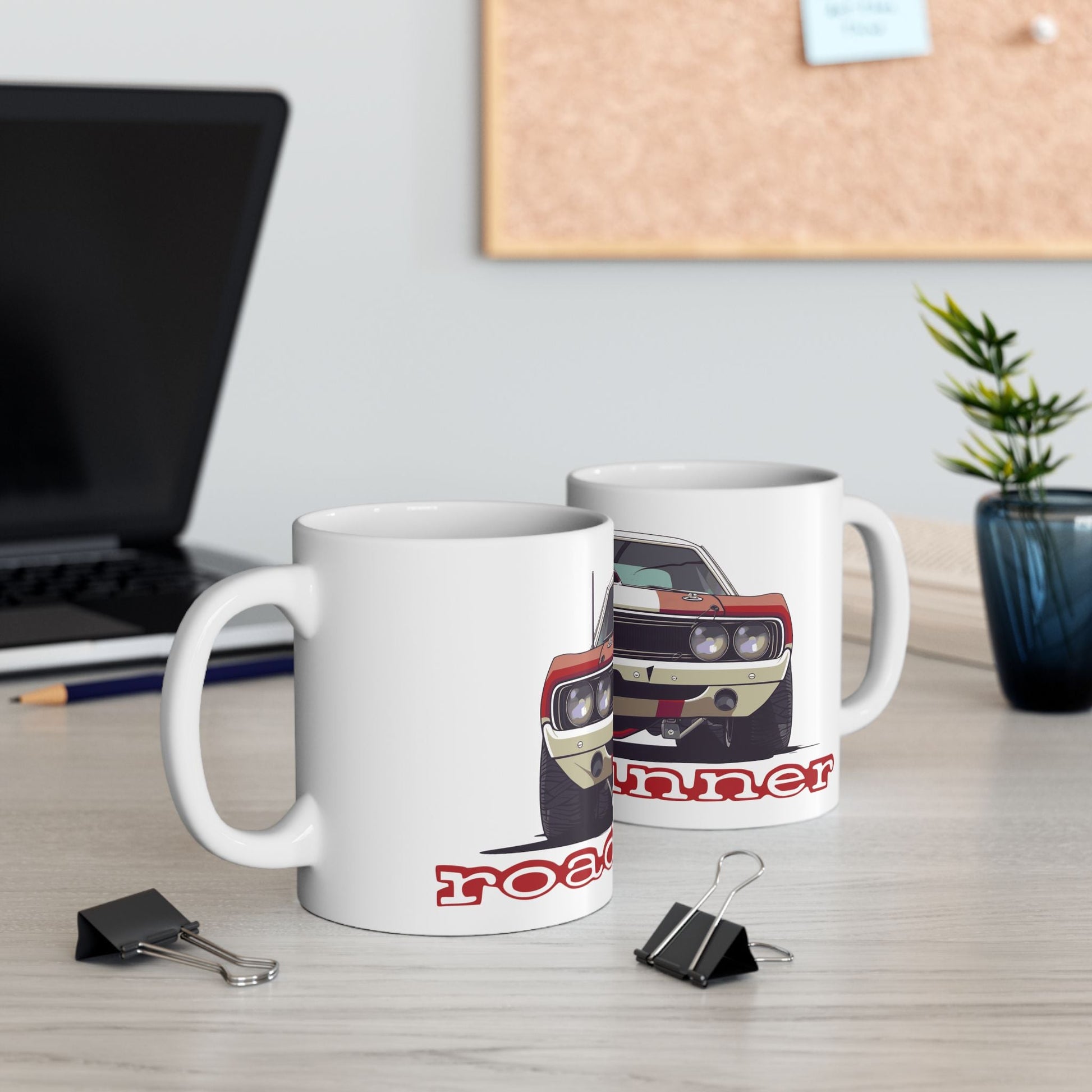 Lifestyle view of the 11oz White Coffee Mug with a Plymouth Roadrunner with the Roadrunner emblem placed under the car. 