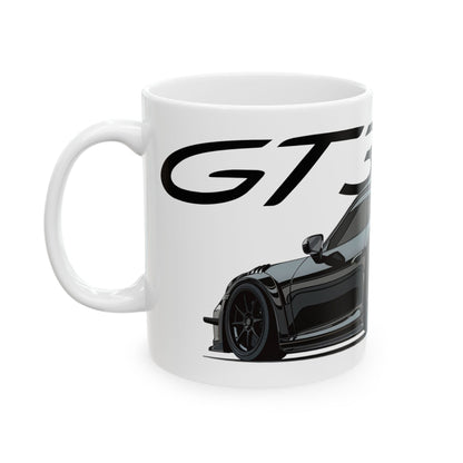 Left view of 11oz White Coffee Mug with a Porsche GT3 with the GT3 emblem placed behind the car.  