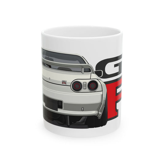 11oz White Coffee Mug with a Nissan Skyline R32 with the GTR emblem placed behind the car. 